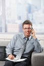 Businessman talking on phone smiling