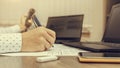 Businessman talking on the phone, using his laptop and making notes on paper while working in the office. Royalty Free Stock Photo