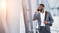 Businessman Talking On Phone, Walking In Airport Royalty Free Stock Photo