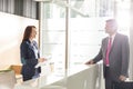 Businessman talking with receptionist in office Royalty Free Stock Photo