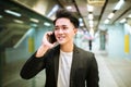 Businessman talking on smart phone and  waiting at the train platform Royalty Free Stock Photo