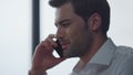 Businessman talking on smartphone in office. Man calling on cellphone Royalty Free Stock Photo