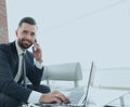 Foreground businessman talking on a smartphone Royalty Free Stock Photo