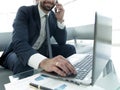 Foreground businessman talking on a smartphone