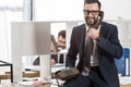 businessman talking by stationary telephone in office and sitting Royalty Free Stock Photo