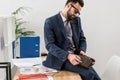 businessman talking by stationary telephone in office and sitting Royalty Free Stock Photo