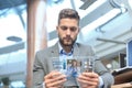 Businessman talking to his colleagues in video conference. Business team working from office using transparent tablet Royalty Free Stock Photo