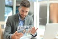 Businessman talking to his colleagues in video conference. Business team working from office using transparent tablet Royalty Free Stock Photo