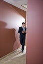 Businessman talking and walking down corridor