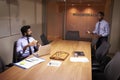 Businessman talks to colleague late in office, elevated view Royalty Free Stock Photo