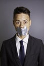 Businessman with tape over mouth Royalty Free Stock Photo