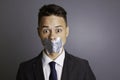 Businessman with tape over mouth Royalty Free Stock Photo