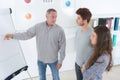 Businessman teaching younger students in modern class