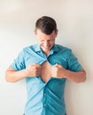 Businessman tearing off his shirt and showing mucular body concept on background Royalty Free Stock Photo