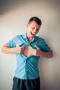 Businessman tearing off his shirt and showing mucular body concept on background Royalty Free Stock Photo