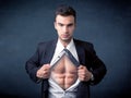 Businessman tearing off shirt and showing mucular body Royalty Free Stock Photo