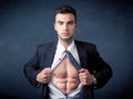 Businessman tearing off shirt and showing mucular body Royalty Free Stock Photo