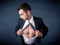 Businessman tearing off shirt and showing mucular body Royalty Free Stock Photo