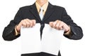 Businessman tearing sheet white paper