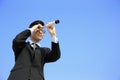 Businessman with telescope looking forward