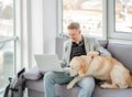 Businessman teleworking next to dog