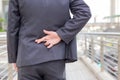 Businessman telling lies, hold crossed finger his back with modern building background