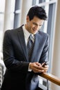 Businessman text messaging on cell phone