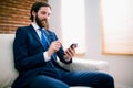 Businessman texting on the couch Royalty Free Stock Photo