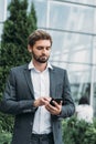 Businessman texting messages while walking