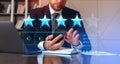 Businessman with smartphone and laptop, giving feedback and review online Royalty Free Stock Photo