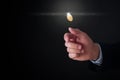 Businessman throwing coin on black background, closeup Royalty Free Stock Photo