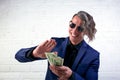Businessman throwing money on white background. Man in suit wear wasting money, throwing banknotes, dollars.