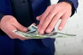 Businessman throwing money on white background. Man in suit wear wasting money, throwing banknotes, dollars.