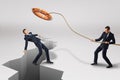 Businessman throwing orange lifebuoy to another businessman who is falling into earthquake crack on white background