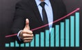 Businessman with thumb up gesture and business graph Royalty Free Stock Photo