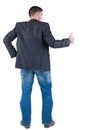 Businessman thumbs up. rear view. Royalty Free Stock Photo