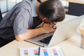 Businessman tired overworked he sleeping over a laptop computer Royalty Free Stock Photo