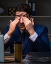 Businessman tired and sleeping in the office after overtime hour Royalty Free Stock Photo