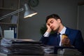 The businessman tired and sleeping in the office after overtime hours Royalty Free Stock Photo