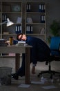 The businessman tired and sleeping in the office after overtime hours Royalty Free Stock Photo