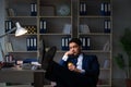 The businessman tired and sleeping in the office after overtime hours Royalty Free Stock Photo