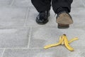 Banana peel accident : businessman about to step on a banana skin, copy space Royalty Free Stock Photo