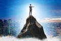 Businessman at the top of mountain in career concept Royalty Free Stock Photo