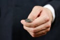 Businessman tossing a coin. Heads or tails. Close up Royalty Free Stock Photo