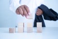 Businessman touches the woodblocks placed on the  table Royalty Free Stock Photo