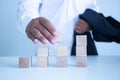 Businessman touches the woodblocks placed on the  table Royalty Free Stock Photo