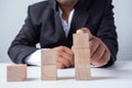 Businessman touches the woodblocks placed on the  table Royalty Free Stock Photo