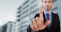 Businessman touching air in front of buildings Royalty Free Stock Photo