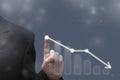 Businessman touching dropping diagram graph. Economy going down. Falling prices, bankruptcy, crisis concept. Blurred defocused Royalty Free Stock Photo