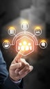Businessman touching a futuristic digital interface with HR, teamwork, data analytics, and global networking icons Royalty Free Stock Photo